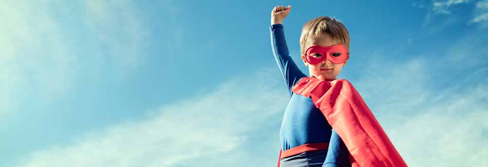 Faschingskostüme selber machen: Ein Junge steht im Superheldenkostüm im Freien