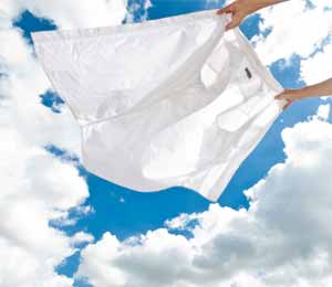 Feinwaschmittel: Eine Bluse flattert vor blauem Himmel im Wind