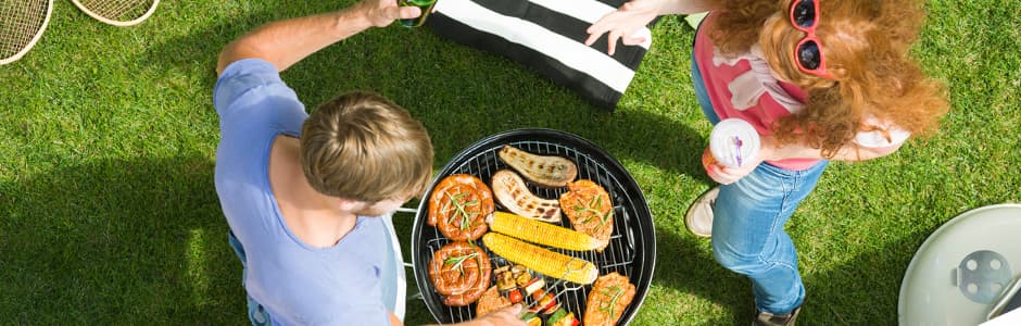 Ein Pärchen grillt gemeinsam im Grünen. Nicht überall herrscht Grillverbot